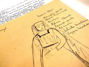 A pen sketch of a costume design for the Virgin Mary. Text reads 